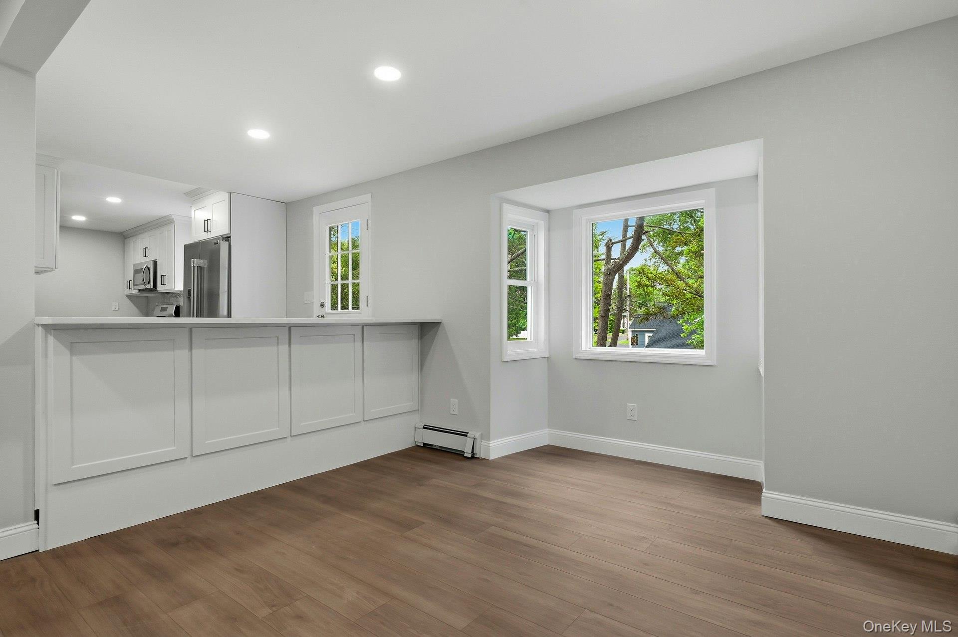 101 Rustic Road Centereach, NY 11720 - Photo 16 of 42 an empty room with windows and cabinet