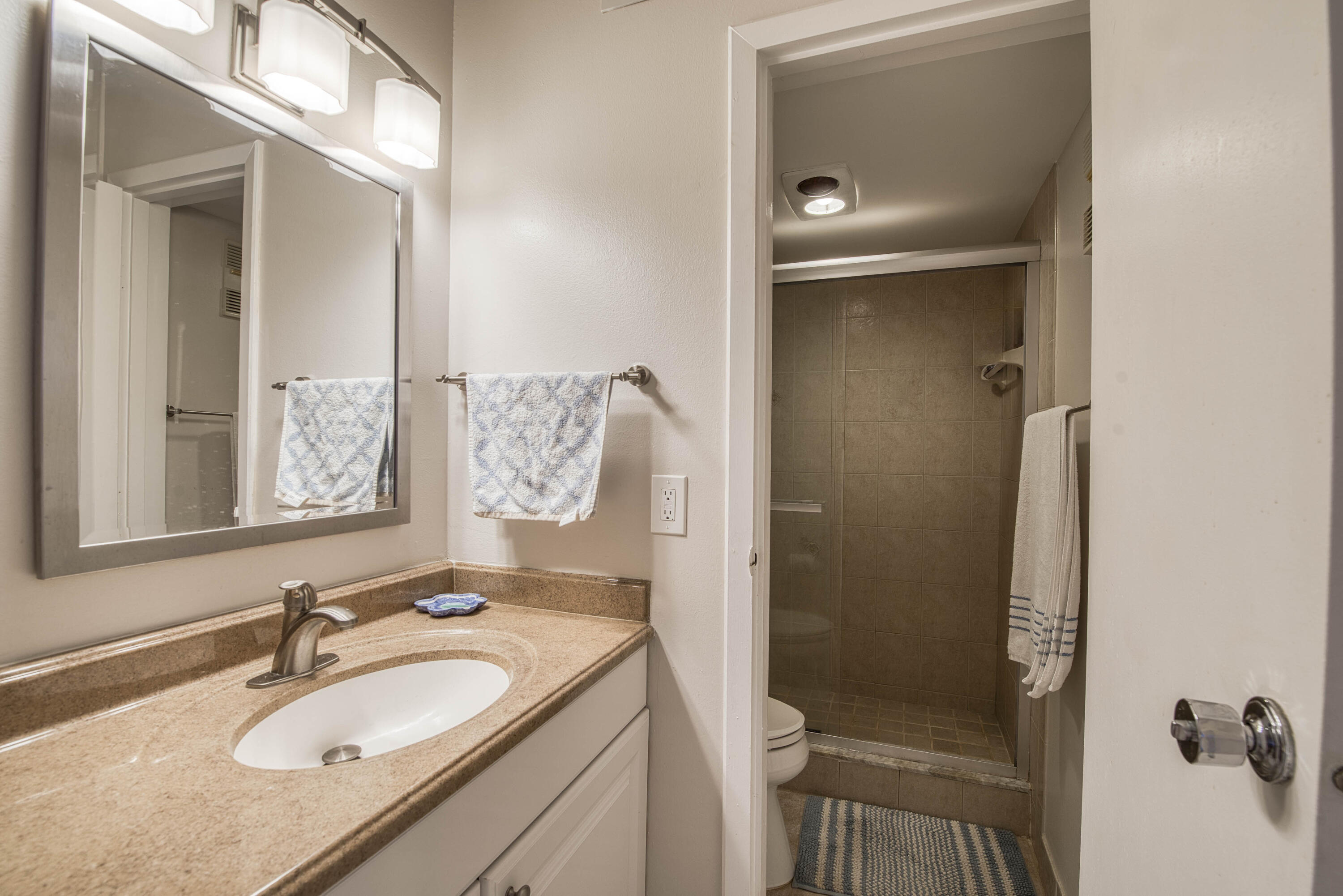 336 Golfview Road, Unit 518 North Palm Beach, FL 33408 - Photo 15 of 31 a bathroom with a granite countertop sink and mirror with shower