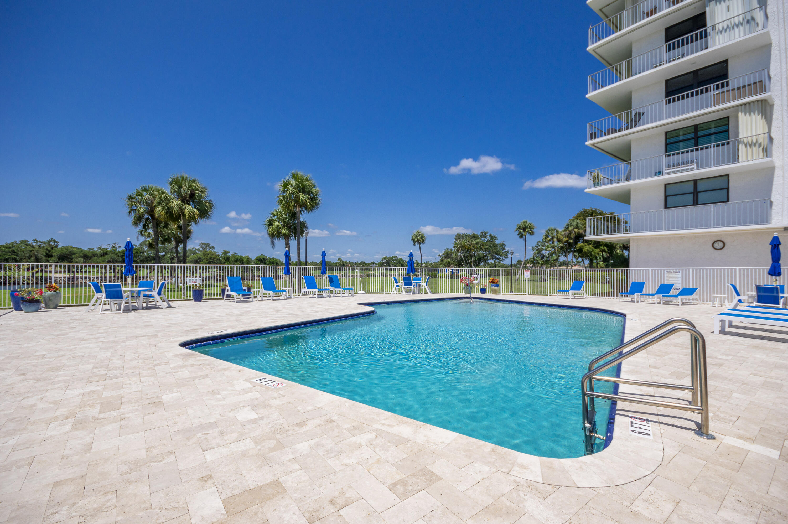 336 Golfview Road, Unit 518 North Palm Beach, FL 33408 - Photo 27 of 31 a view of a swimming pool with a lounge chairs