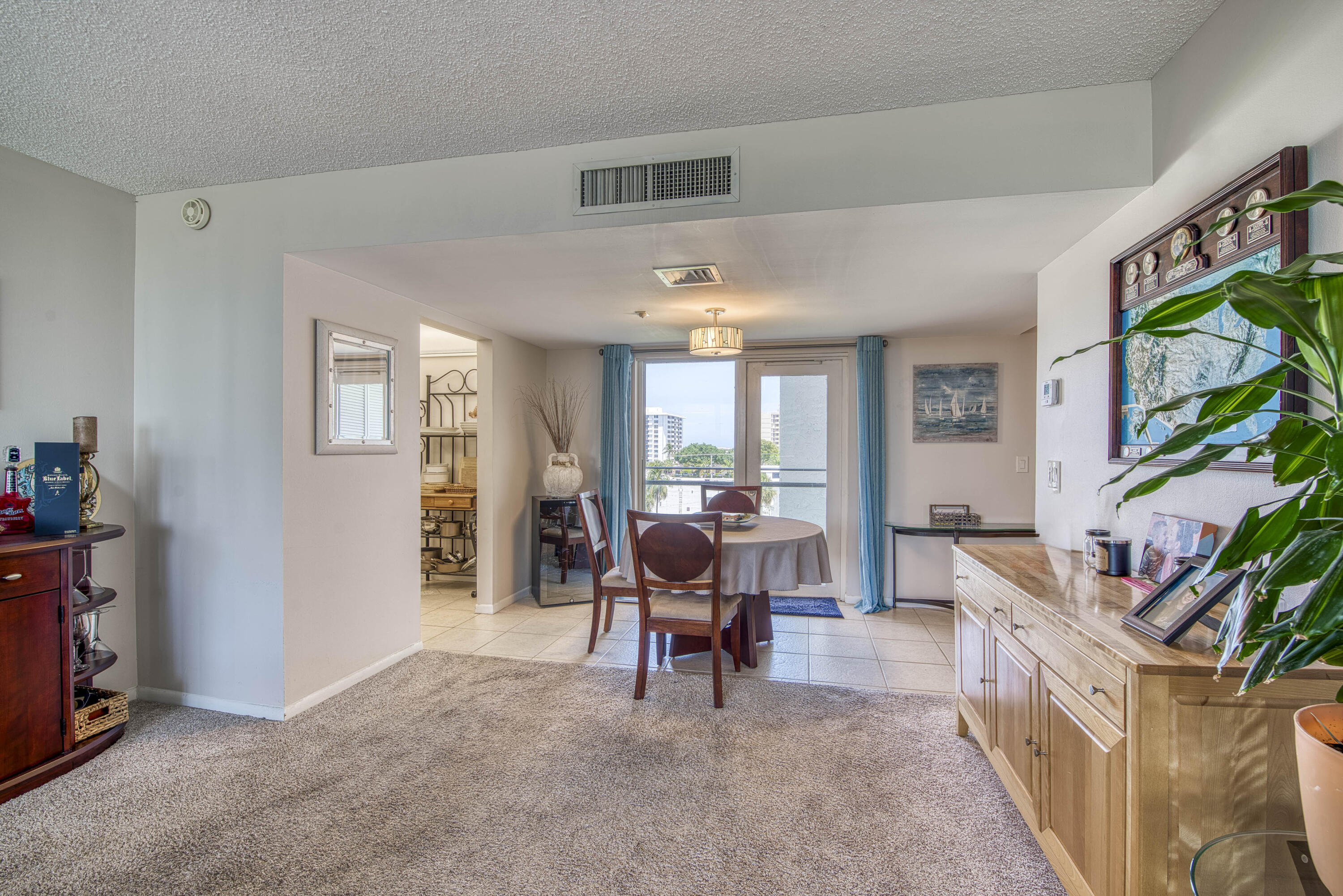 336 Golfview Road, Unit 518 North Palm Beach, FL 33408 - Photo 9 of 31 a living room with furniture and a large window