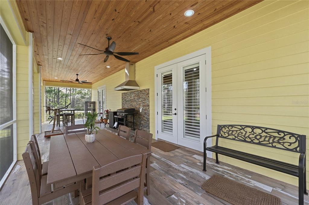 2204 Re Byrd Road Frostproof, FL 33843 - Photo 29 of 49 a view of a patio with a table chairs and a barbeque