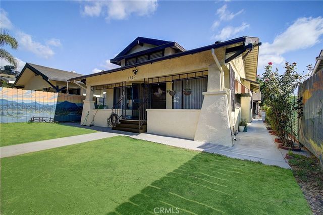 a view of a house with a back yard