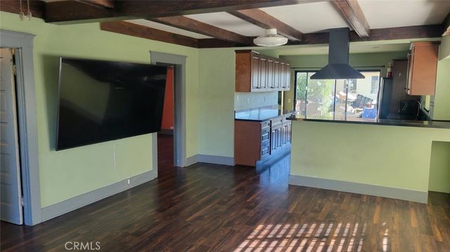 a view of a room with wooden floor and staircase