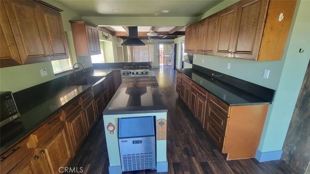 a kitchen with wooden cabinets and a stove top oven