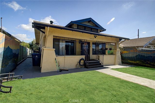 a view of a house with yard and sitting area