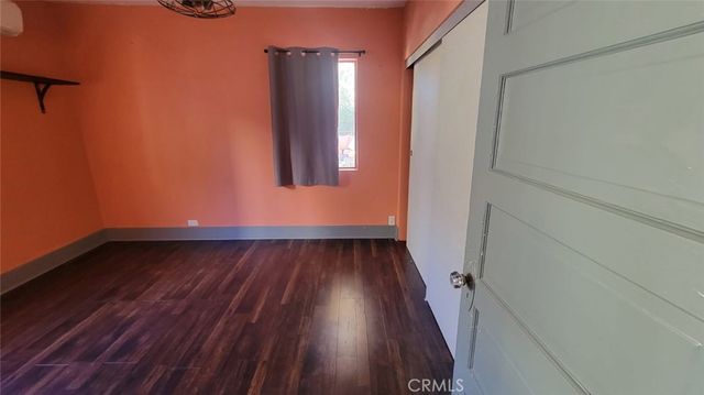 a view of a room with wooden floor and white walls