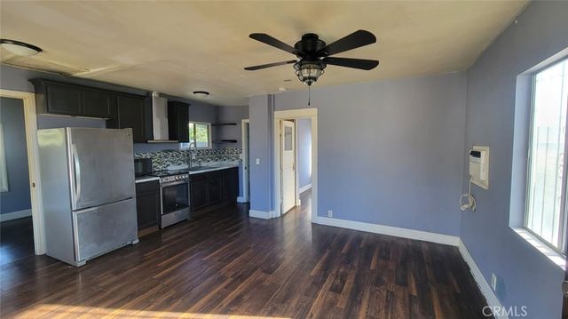 a kitchen with a refrigerator and a sink