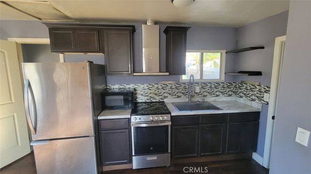 a kitchen with stainless steel appliances a refrigerator and a sink