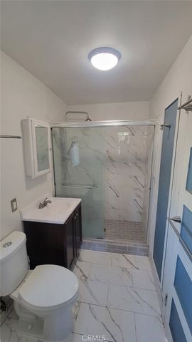 a bathroom with a toilet a sink and shower