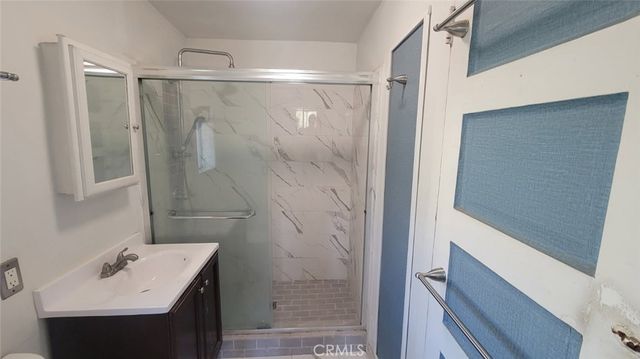 a bathroom with a sink a mirror and shower