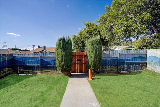 a view of a backyard with a garden and trees