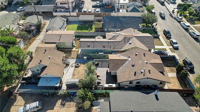 an aerial view of multiple houses with yard