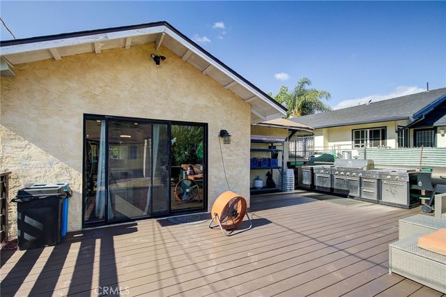 a view of outdoor kitchen and dining room