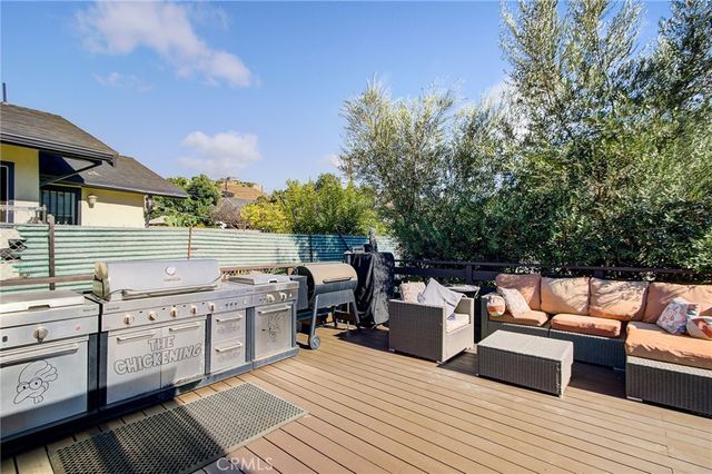a view of a patio with couches chairs and wooden floor