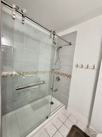 a bathroom with a shower and a mirror