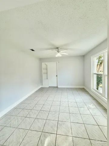 an empty room with white walls and windows