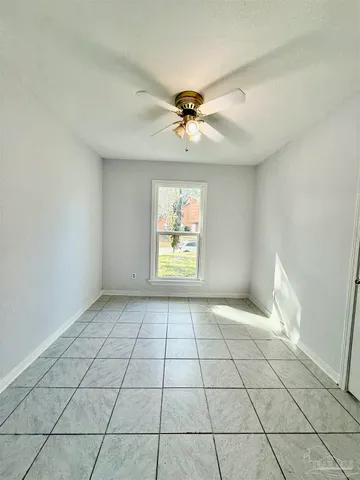 a view of an empty room and window chandelier fan