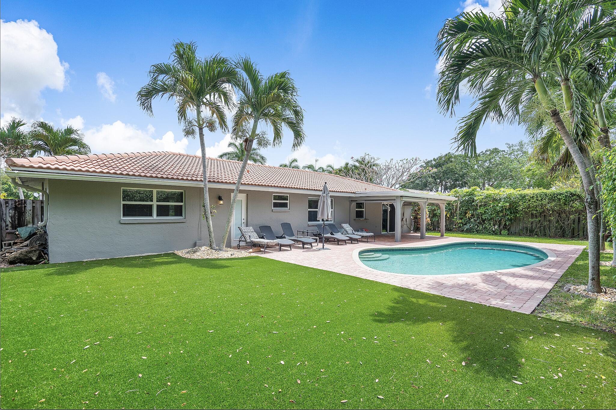 3289 Northwest 26th Avenue Boca Raton, FL 33434 - Photo 4 of 10 a front view of house with yard and outdoor seating