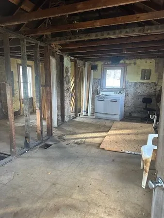 a view of a room with wooden floor and windows