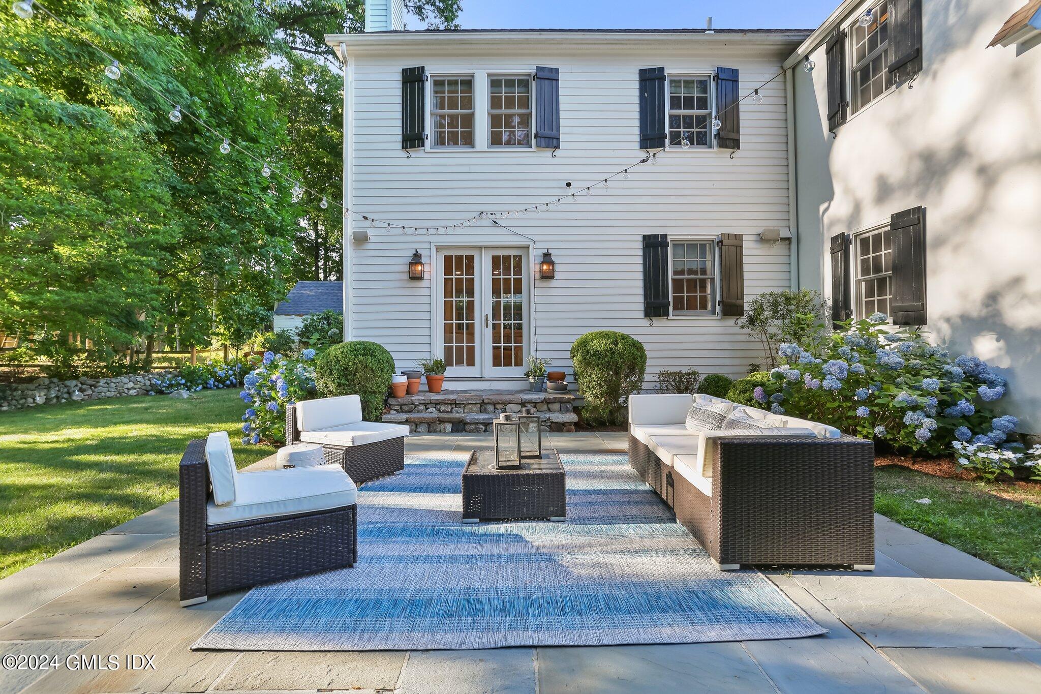 46 Terrace Avenue Riverside, CT 06878 - Photo 14 of 17 a view of a patio with couches table and chairs with plants and garden
