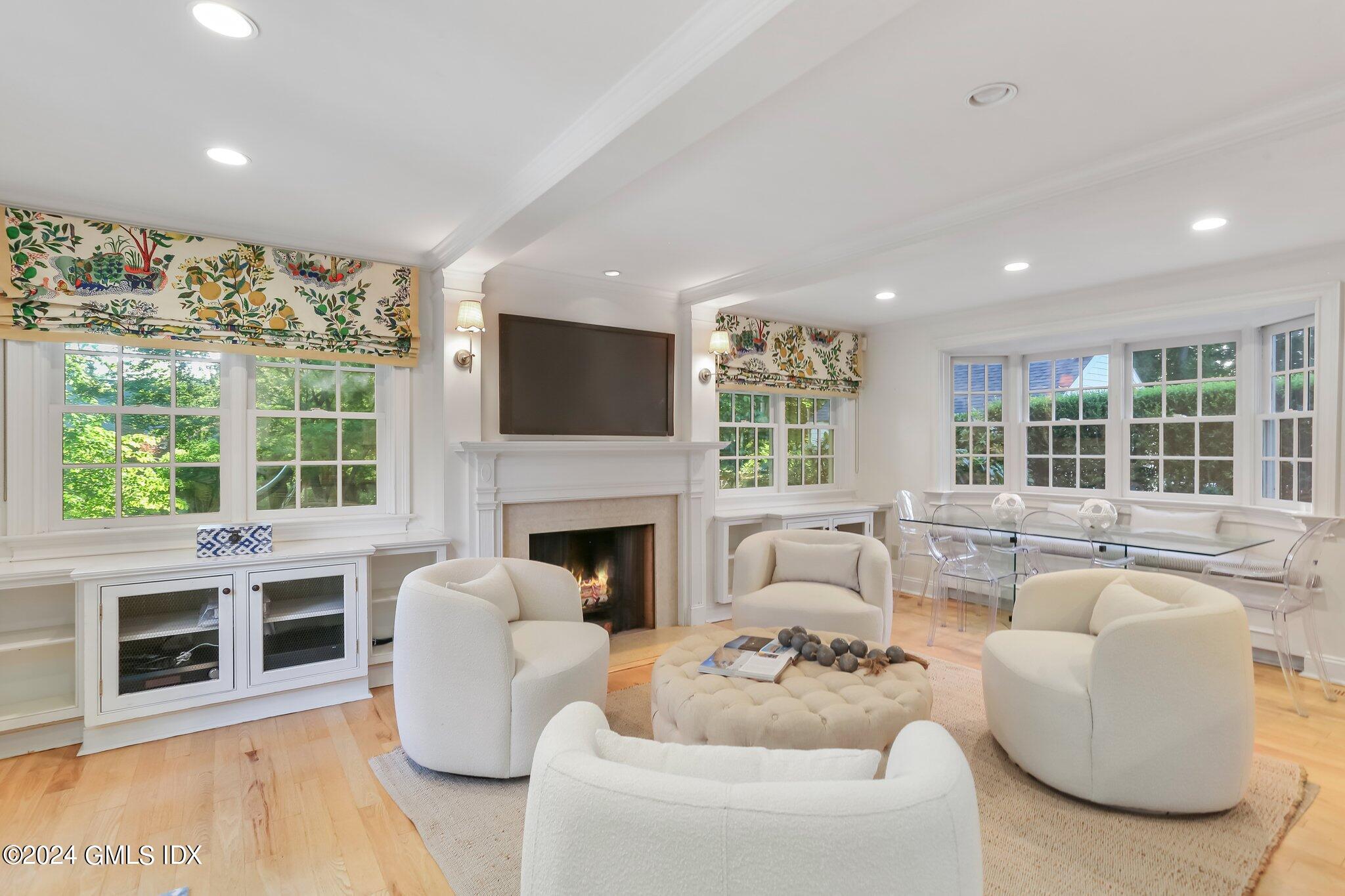 46 Terrace Avenue Riverside, CT 06878 - Photo 8 of 17 a living room with furniture a fireplace and a large window