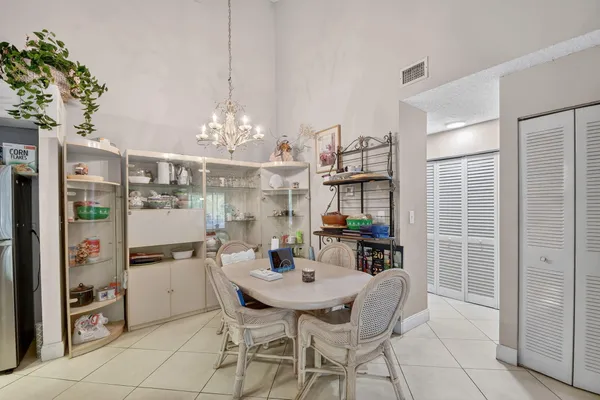 a view of a dining room with furniture and chandelier