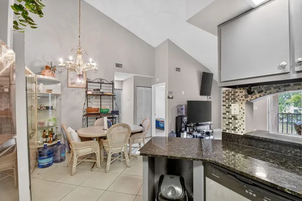 a kitchen with granite countertop a sink and a stove top oven