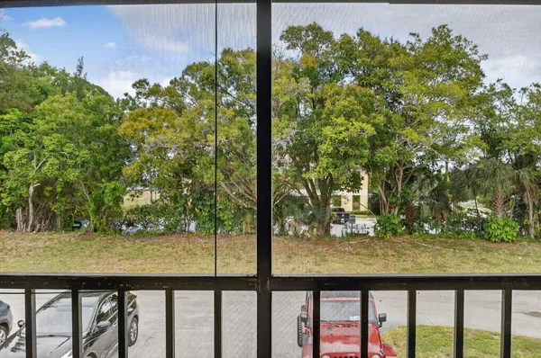 a view of roof deck with chair and wooden floor