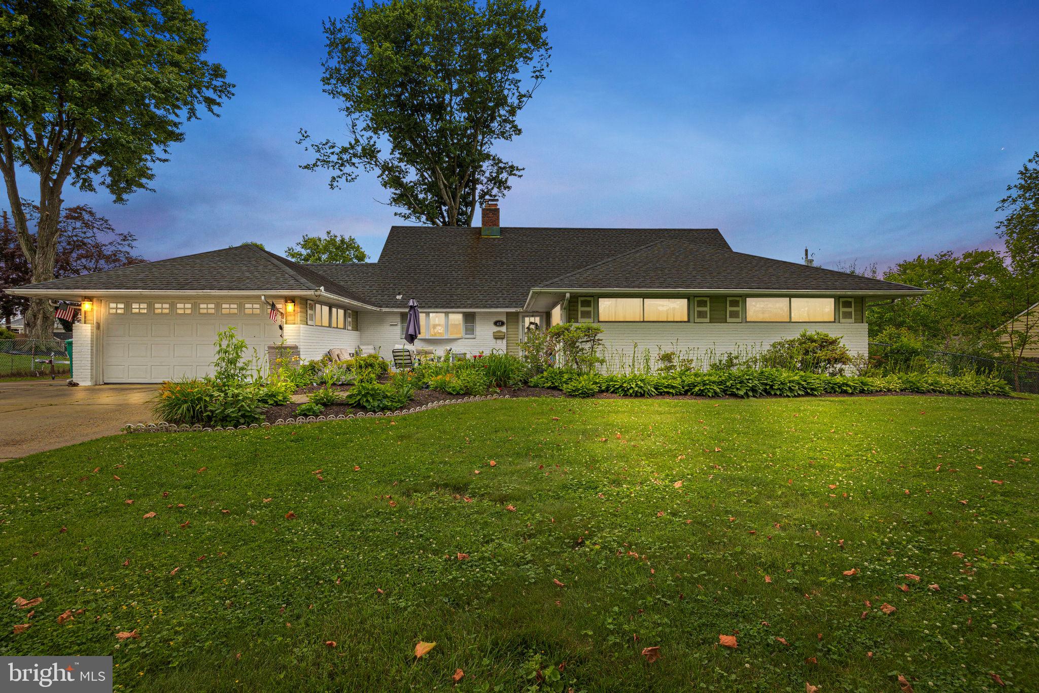 65 Silverspruce Road Levittown, PA 19056 - Photo 1 of 32 a view of a large garden with an outdoor space and seating area