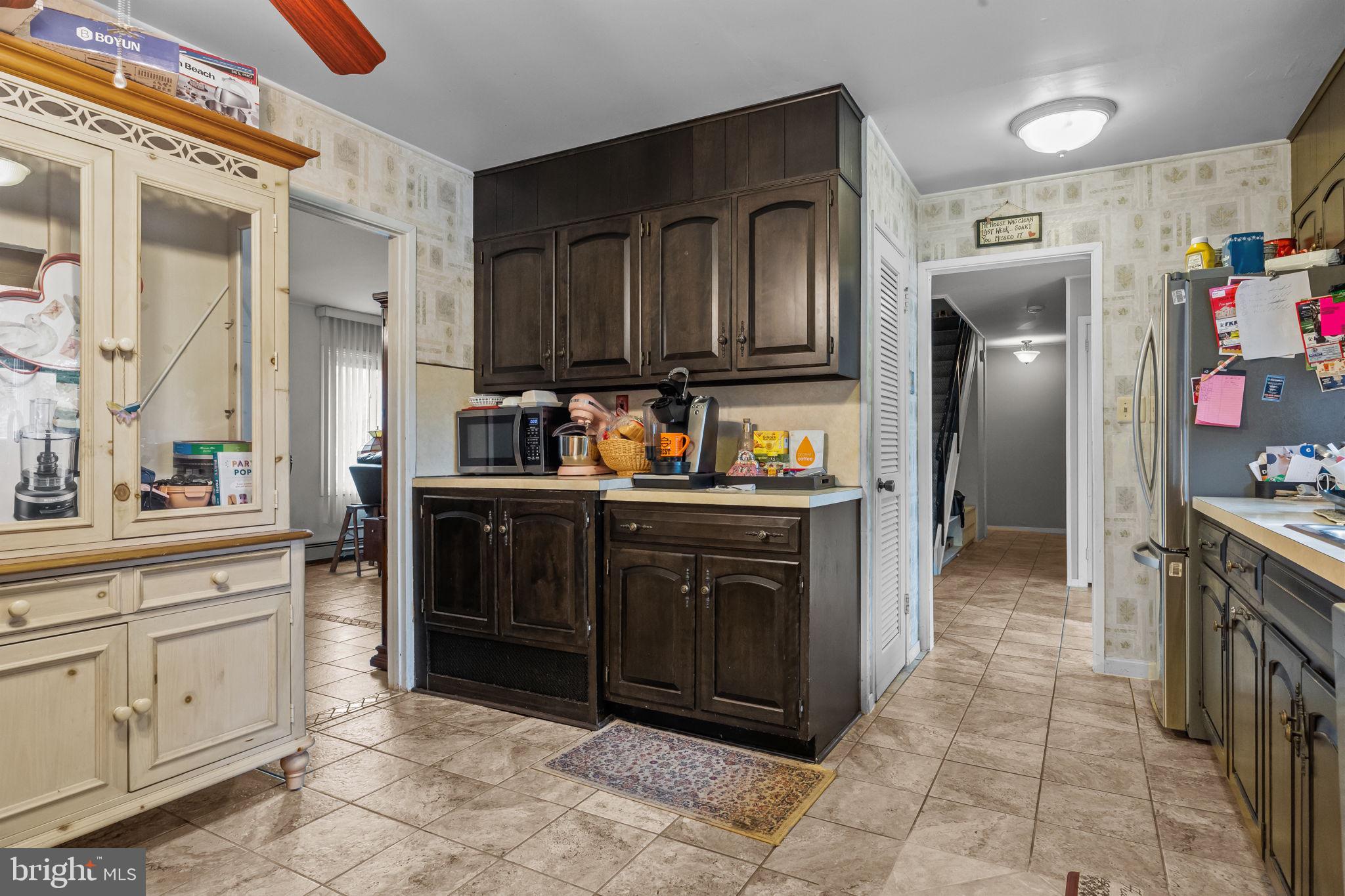 65 Silverspruce Road Levittown, PA 19056 - Photo 11 of 32 a kitchen with stainless steel appliances granite countertop a refrigerator and a stove top oven