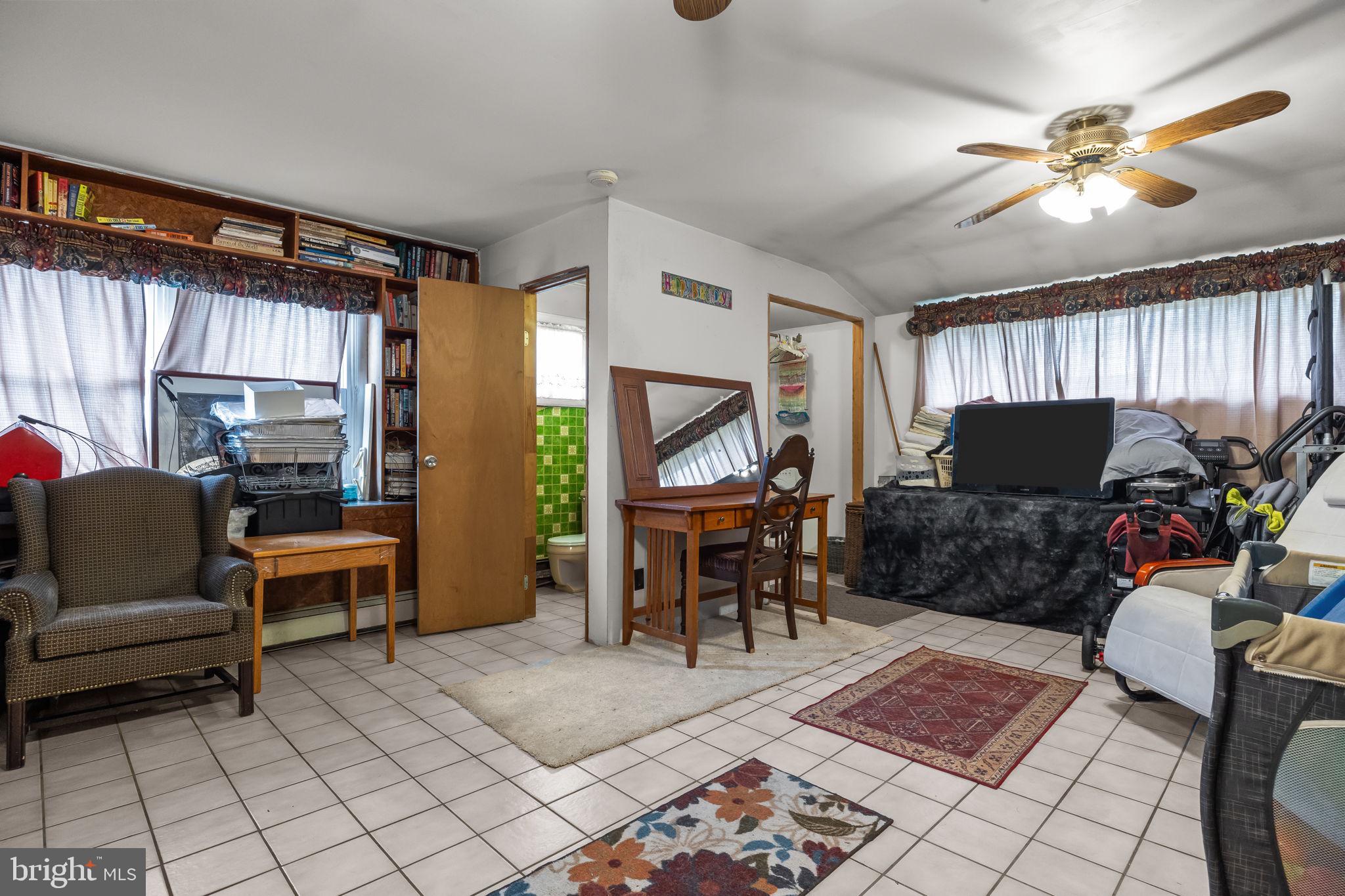 65 Silverspruce Road Levittown, PA 19056 - Photo 14 of 32 a living room with furniture a rug and a window
