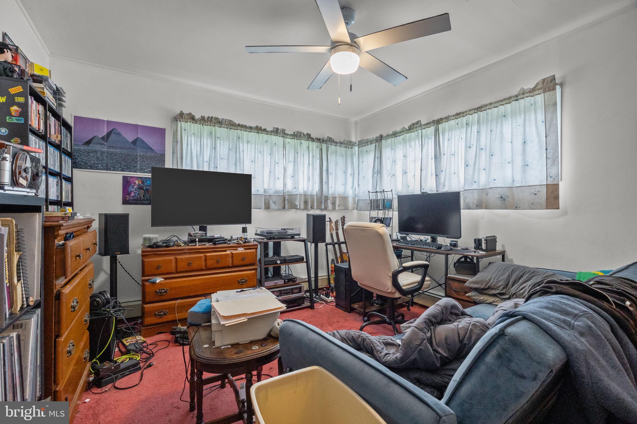 65 Silverspruce Road Levittown, PA 19056 - Photo 18 of 32 a bedroom with furniture a flat screen tv and a window