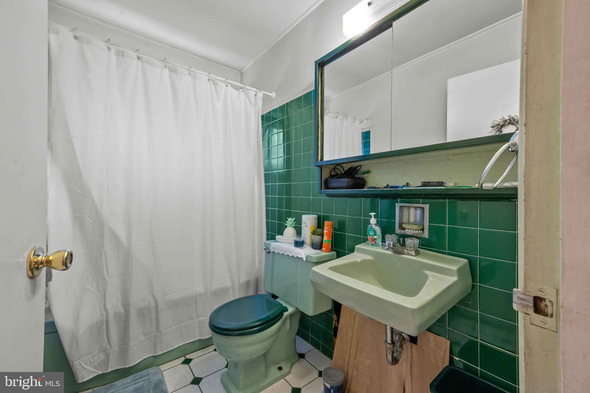 65 Silverspruce Road Levittown, PA 19056 - Photo 19 of 32 a bathroom with a sink a toilet and shower