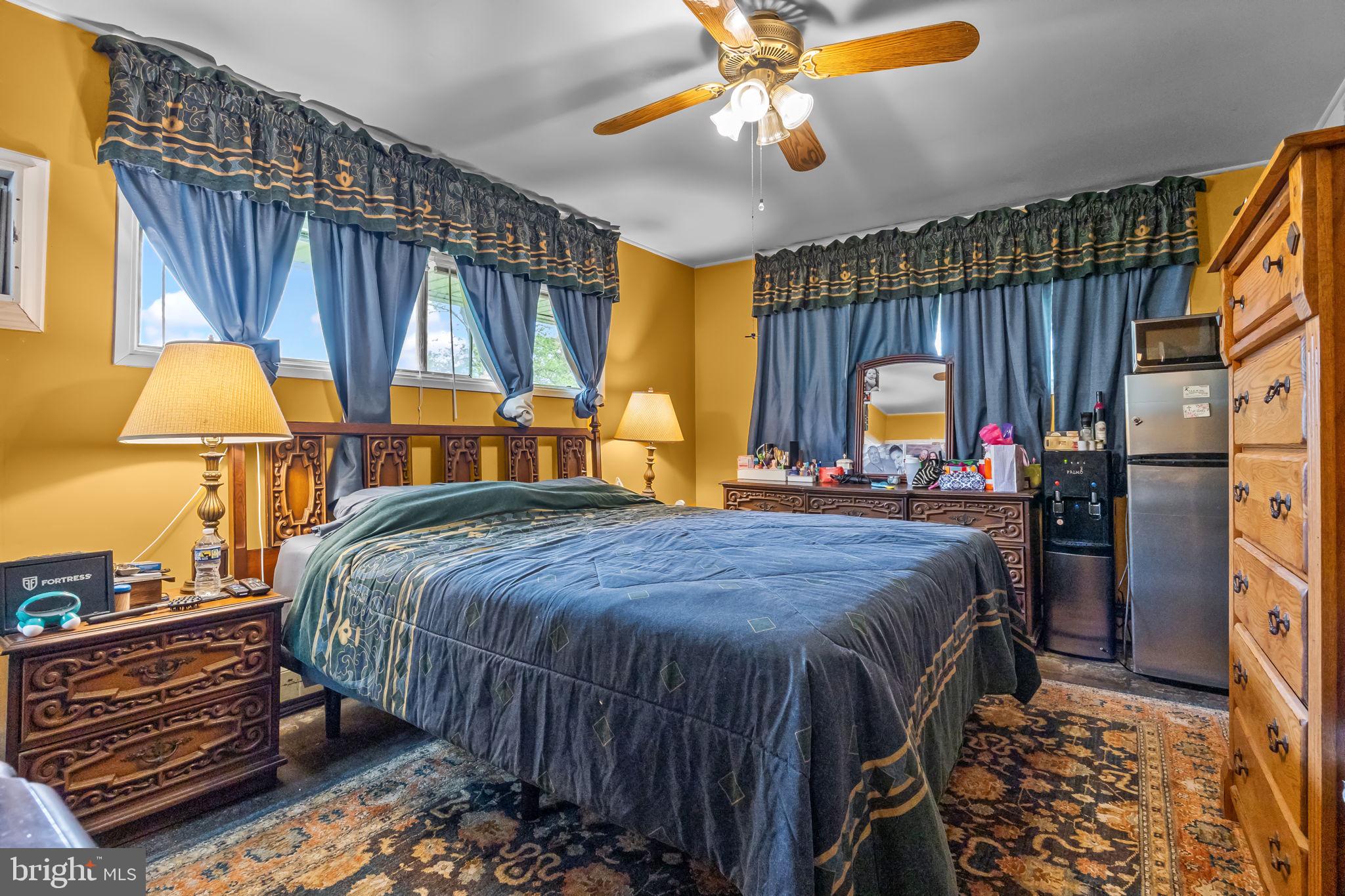 65 Silverspruce Road Levittown, PA 19056 - Photo 20 of 32 a bedroom with a bed and a chandelier