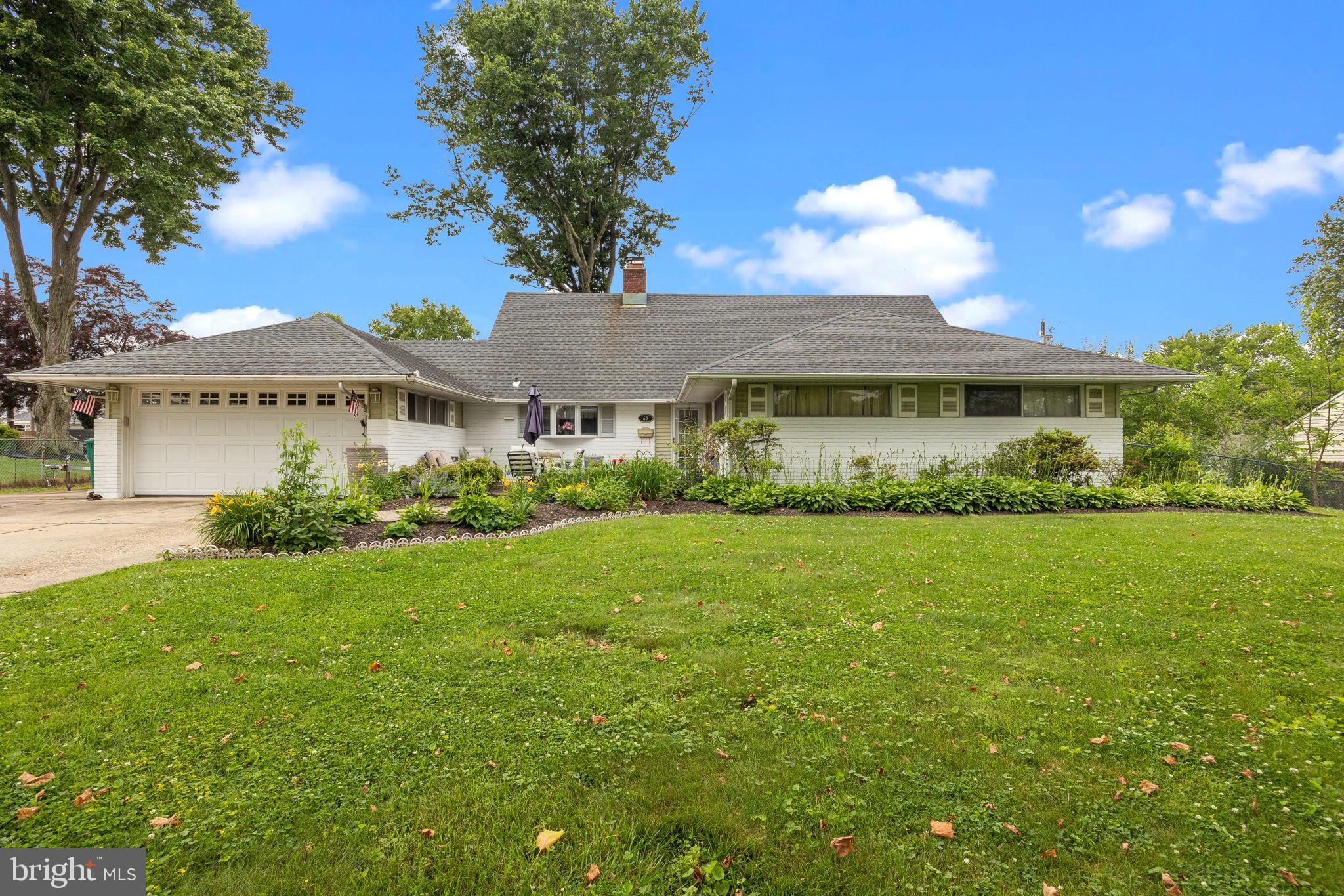 65 Silverspruce Road Levittown, PA 19056 - Photo 2 of 32 a view of a big house with a big yard and large trees