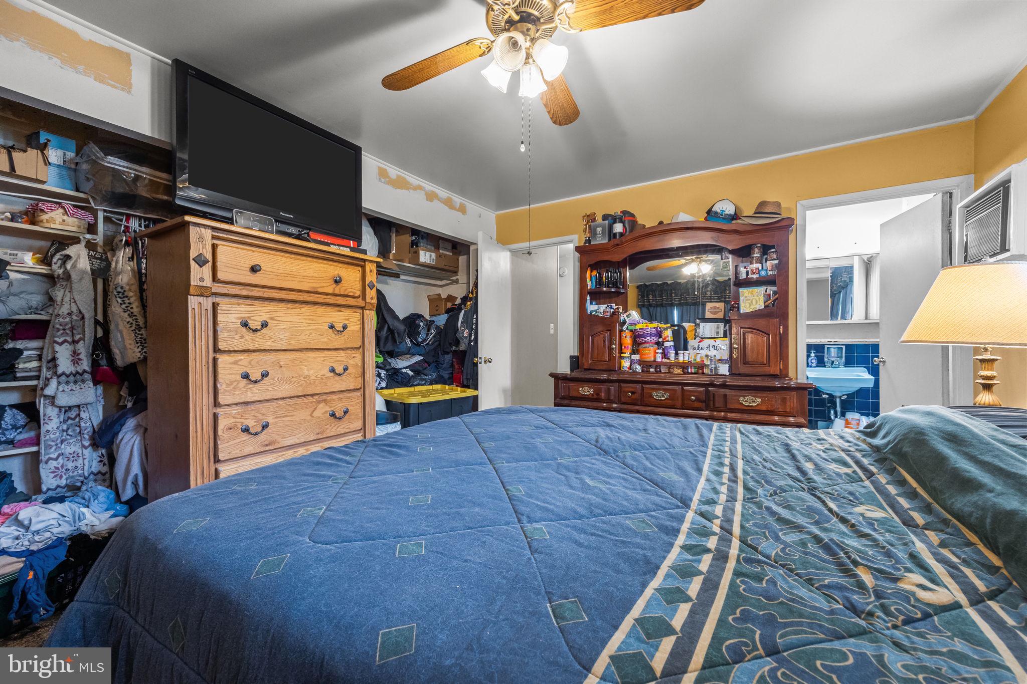 65 Silverspruce Road Levittown, PA 19056 - Photo 21 of 32 a bed room with a bed and a walk in closet