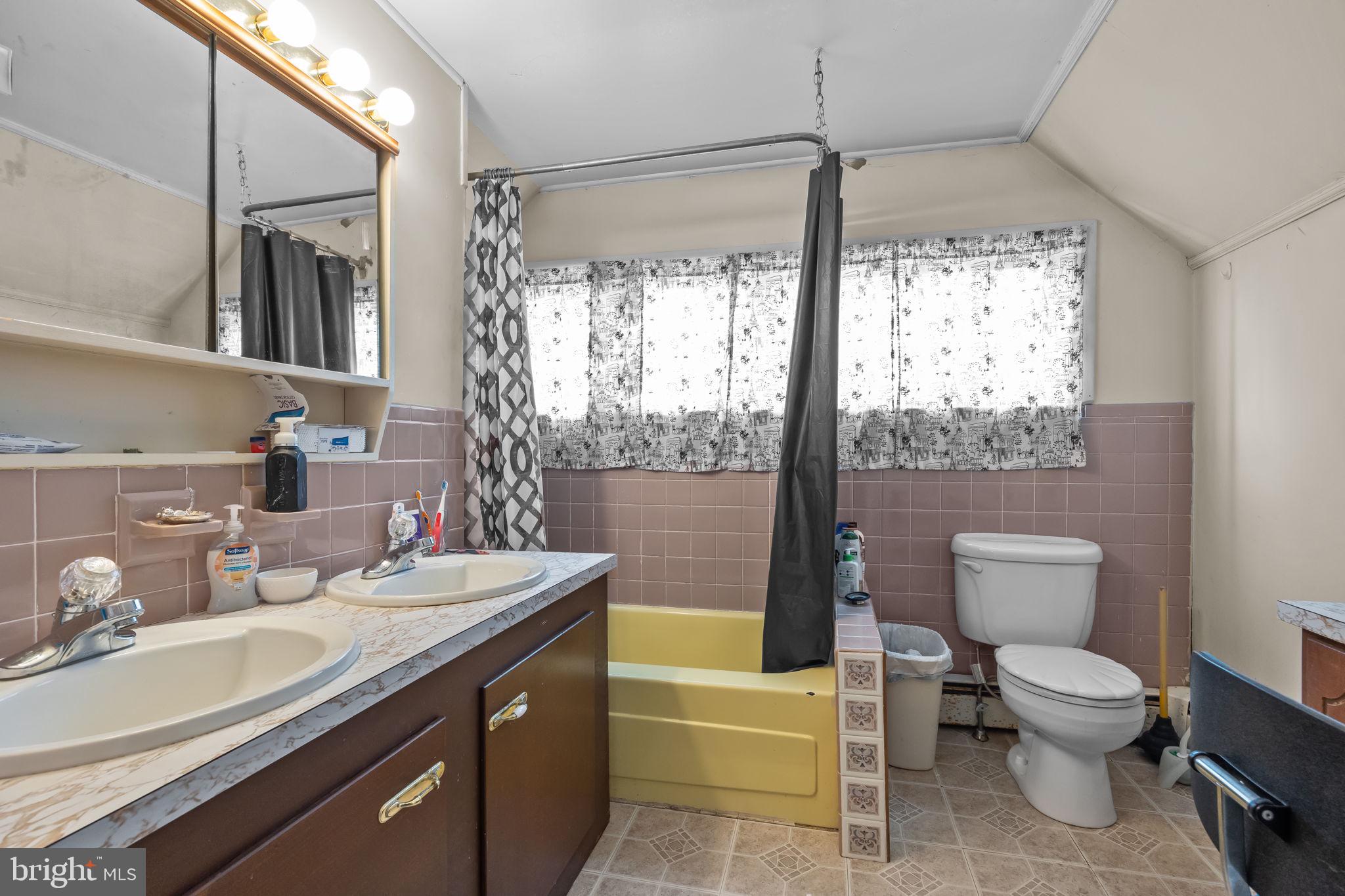 65 Silverspruce Road Levittown, PA 19056 - Photo 23 of 32 a bathroom with a sink toilet and tub