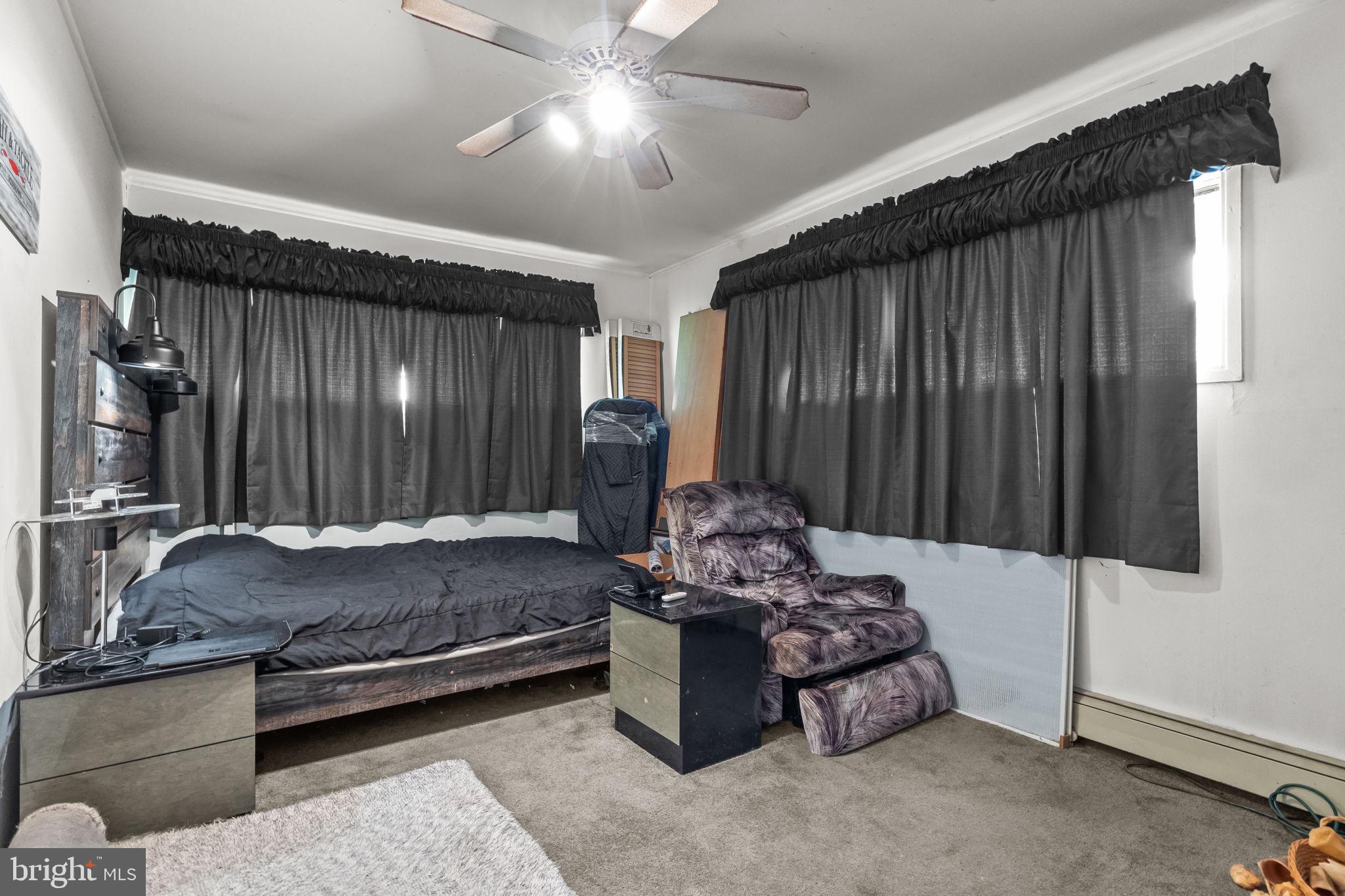 65 Silverspruce Road Levittown, PA 19056 - Photo 27 of 32 a bed room with furniture and a chandelier