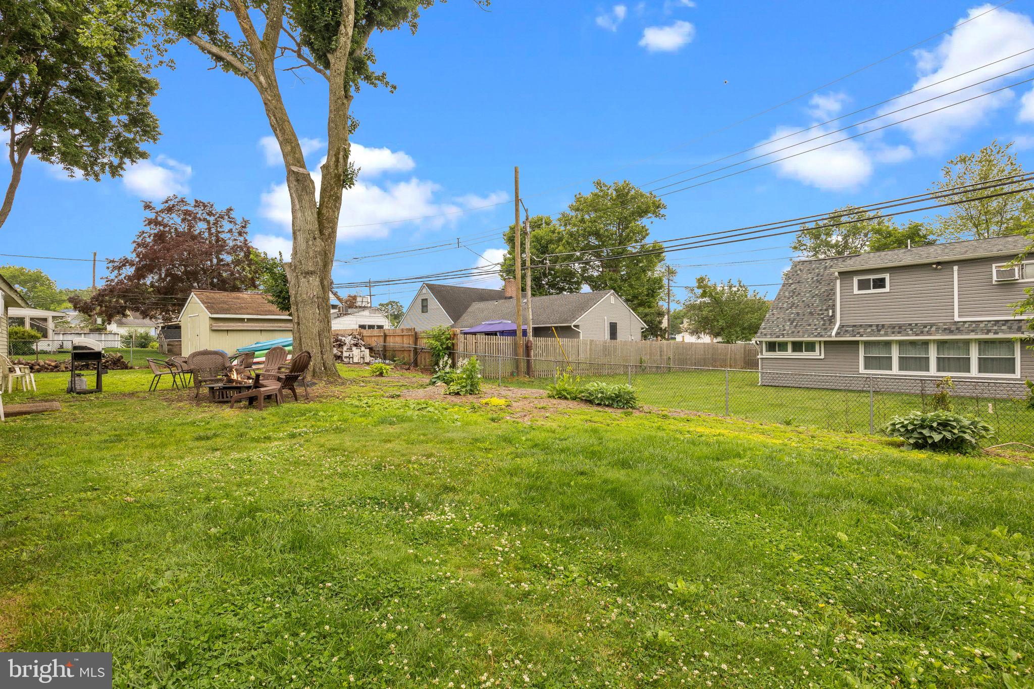 65 Silverspruce Road Levittown, PA 19056 - Photo 29 of 32 a view of a house with a big yard and large trees
