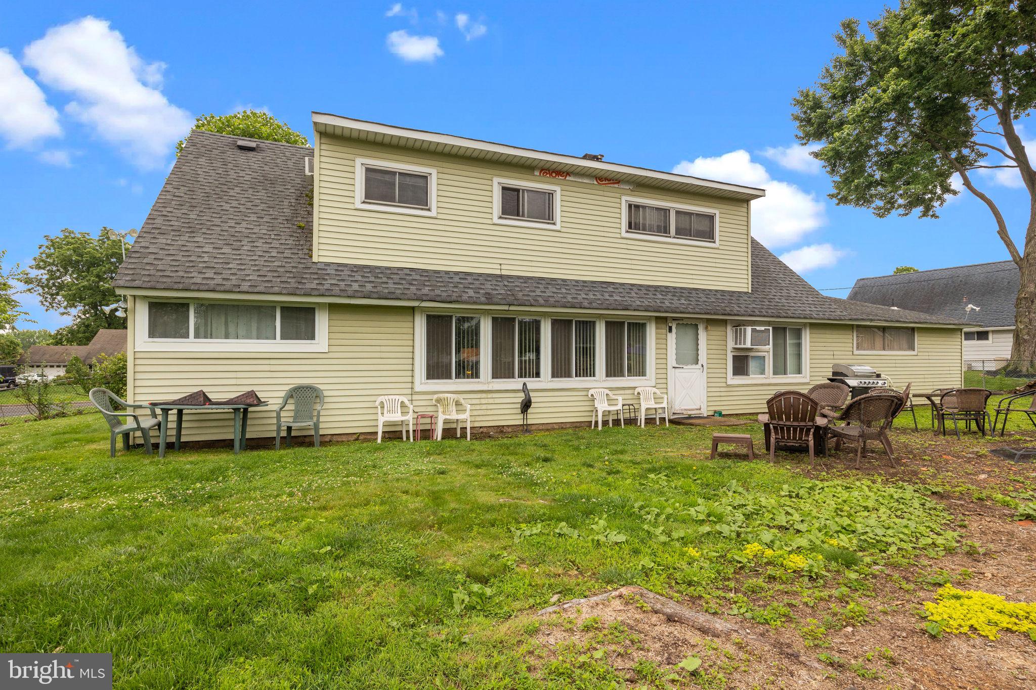 65 Silverspruce Road Levittown, PA 19056 - Photo 30 of 32 a front view of a house with a garden and chairs
