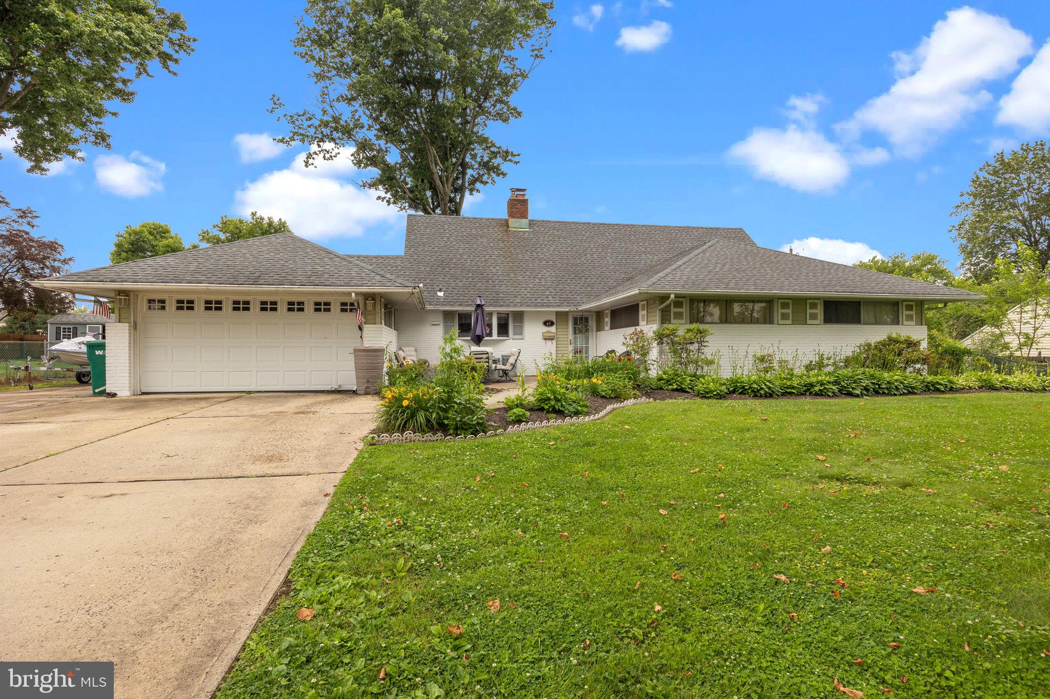 65 Silverspruce Road Levittown, PA 19056 - Photo 3 of 32 a front view of a house with a garden