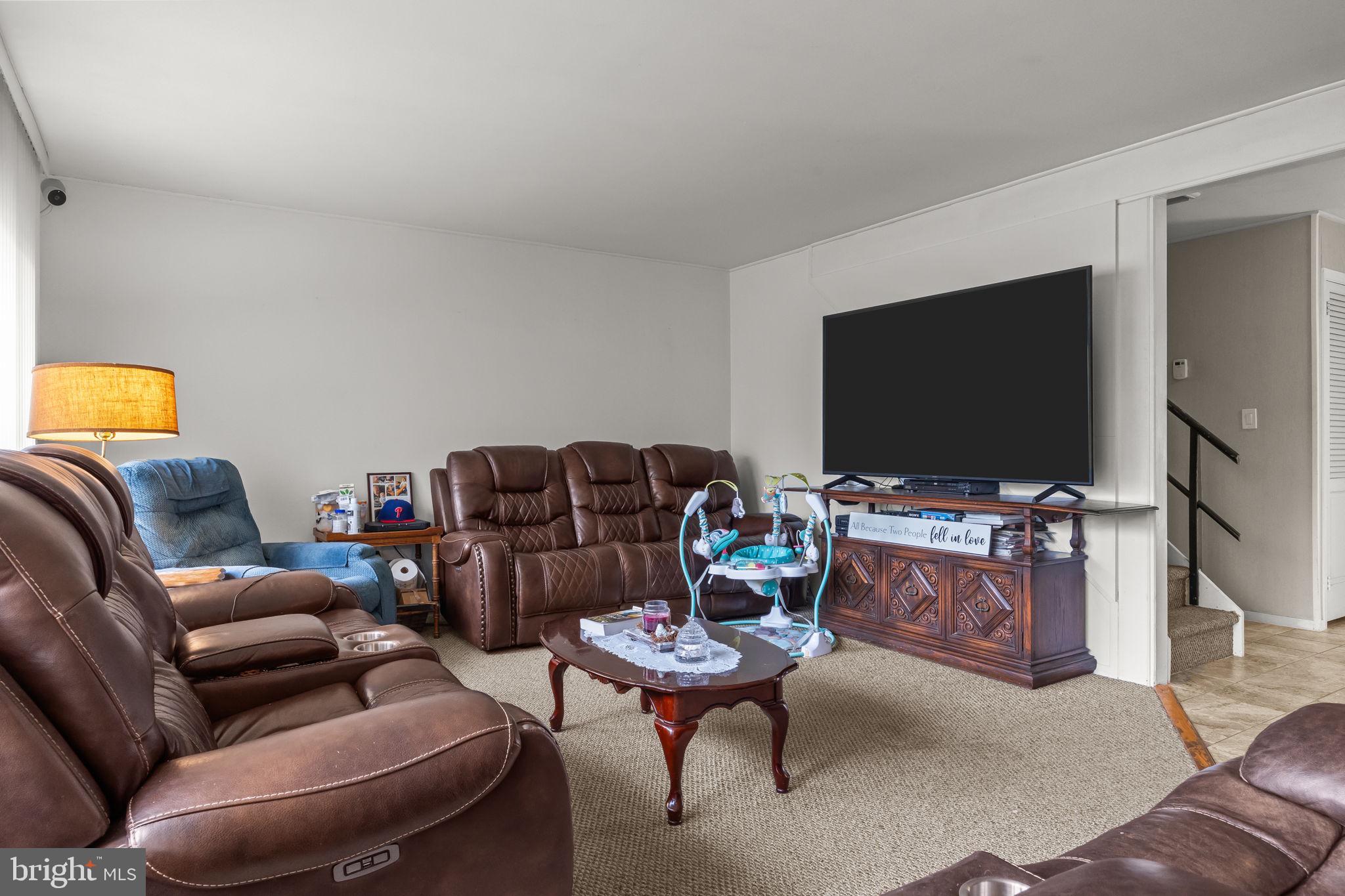 65 Silverspruce Road Levittown, PA 19056 - Photo 7 of 32 a living room with furniture and a flat screen tv