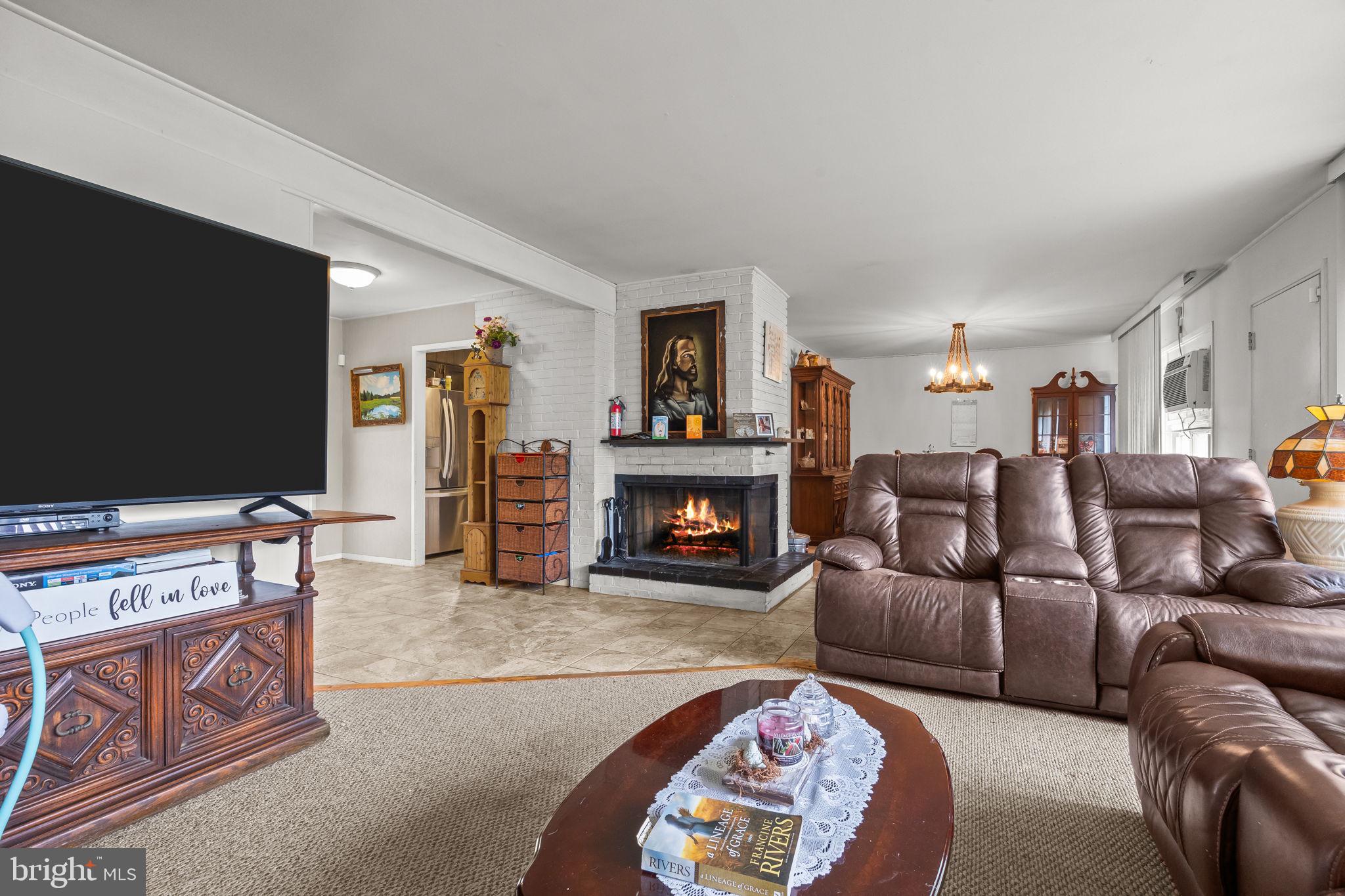 65 Silverspruce Road Levittown, PA 19056 - Photo 8 of 32 a living room with furniture and a fireplace