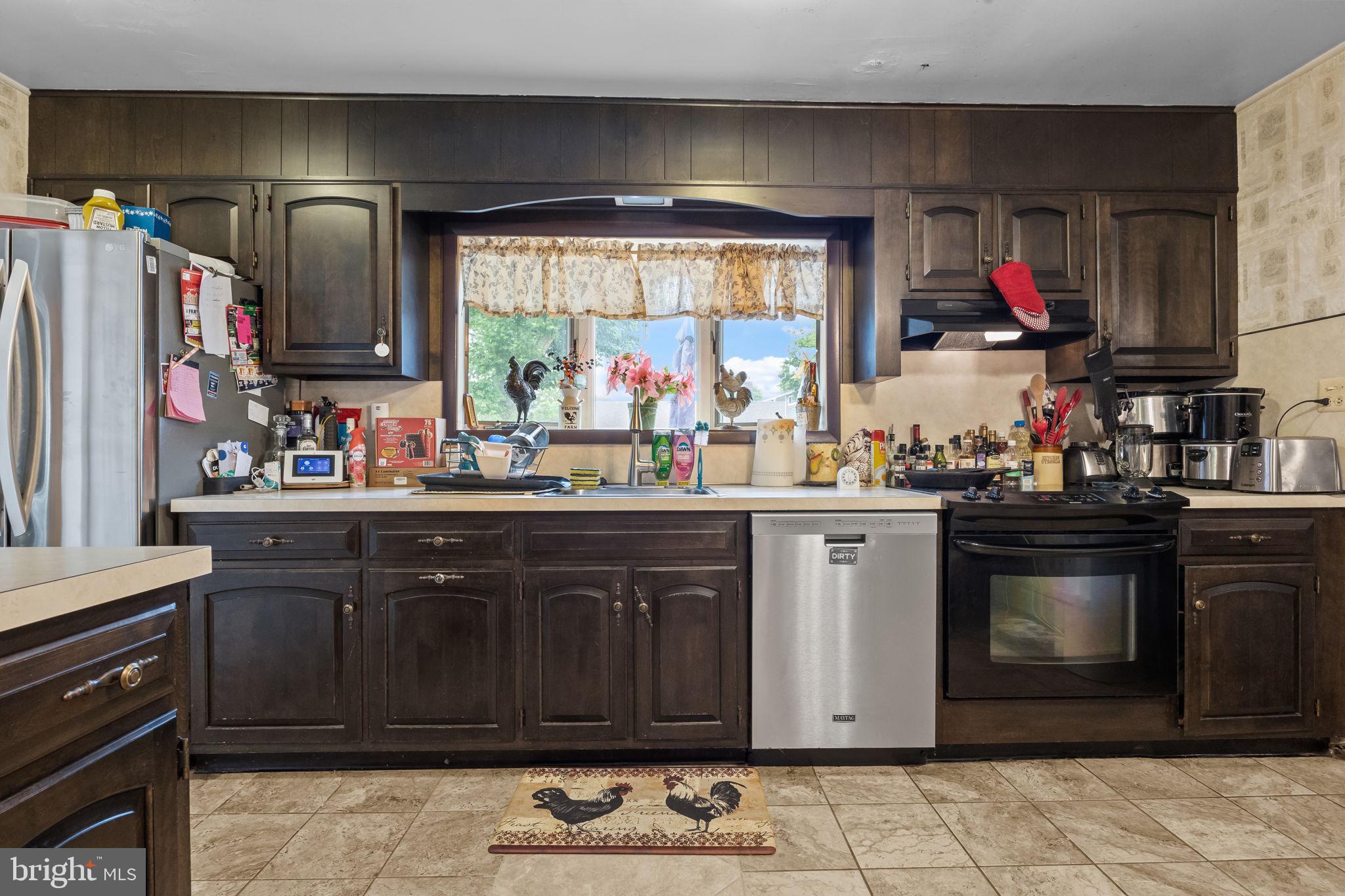 65 Silverspruce Road Levittown, PA 19056 - Photo 9 of 32 a kitchen with stainless steel appliances a stove and cabinets