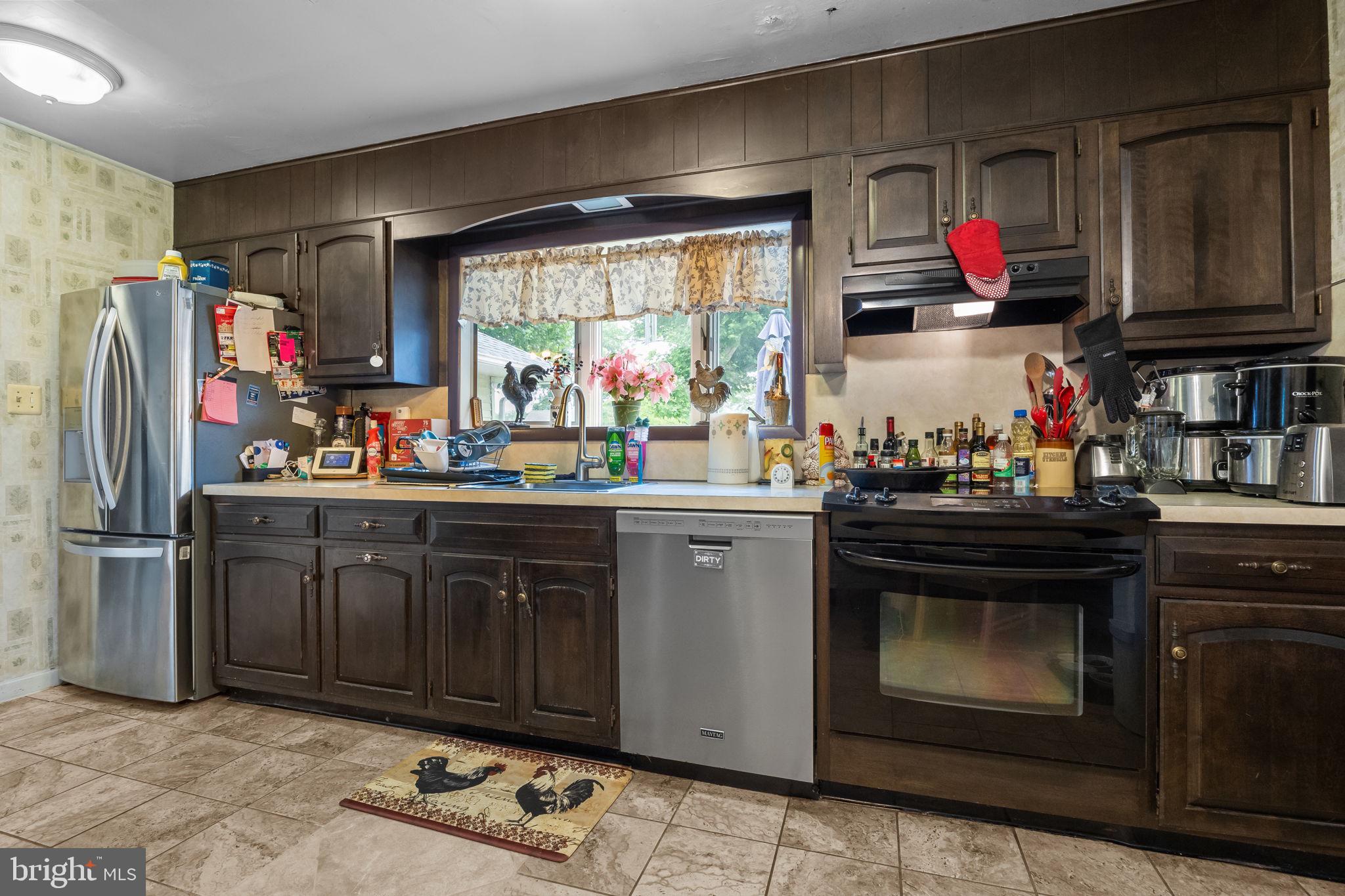 65 Silverspruce Road Levittown, PA 19056 - Photo 10 of 32 a kitchen with stainless steel appliances granite countertop a refrigerator and stove