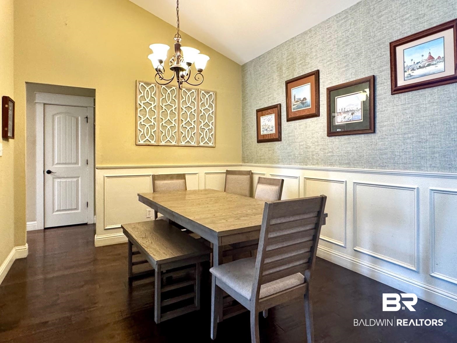 1030 Crown Walk Drive Foley, AL 36535 - Photo 6 of 40 Dining room with vaulted ceiling, wainscoting, dark wood-type flooring, and a chandelier