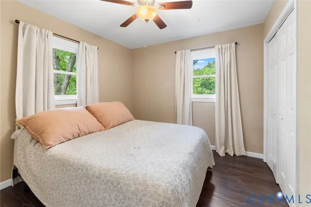 a large bed sitting in a bedroom next to a window