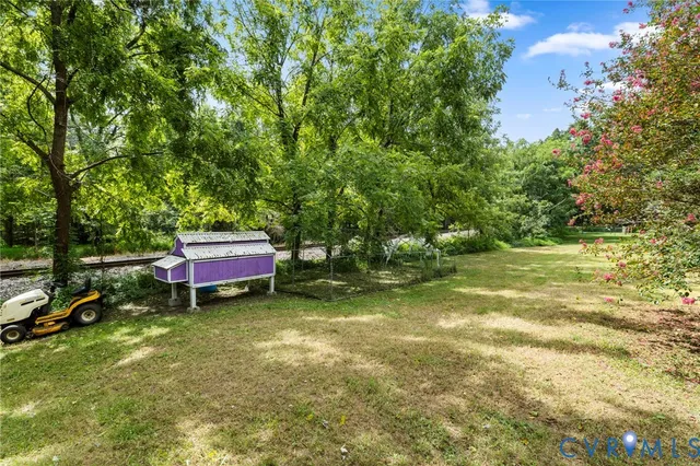 a backyard of a house with yard and outdoor seating