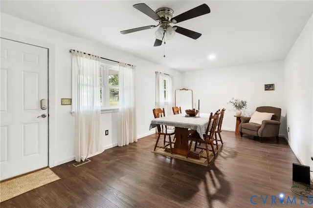 a view of a dining room with furniture and a chandelier fan