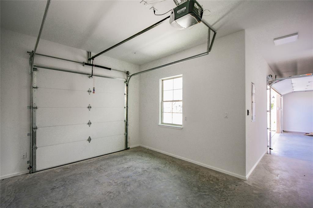 2719 Village Road Granbury, TX 76049 - Photo 31 of 35 Golf Cart Garage looking into Garage